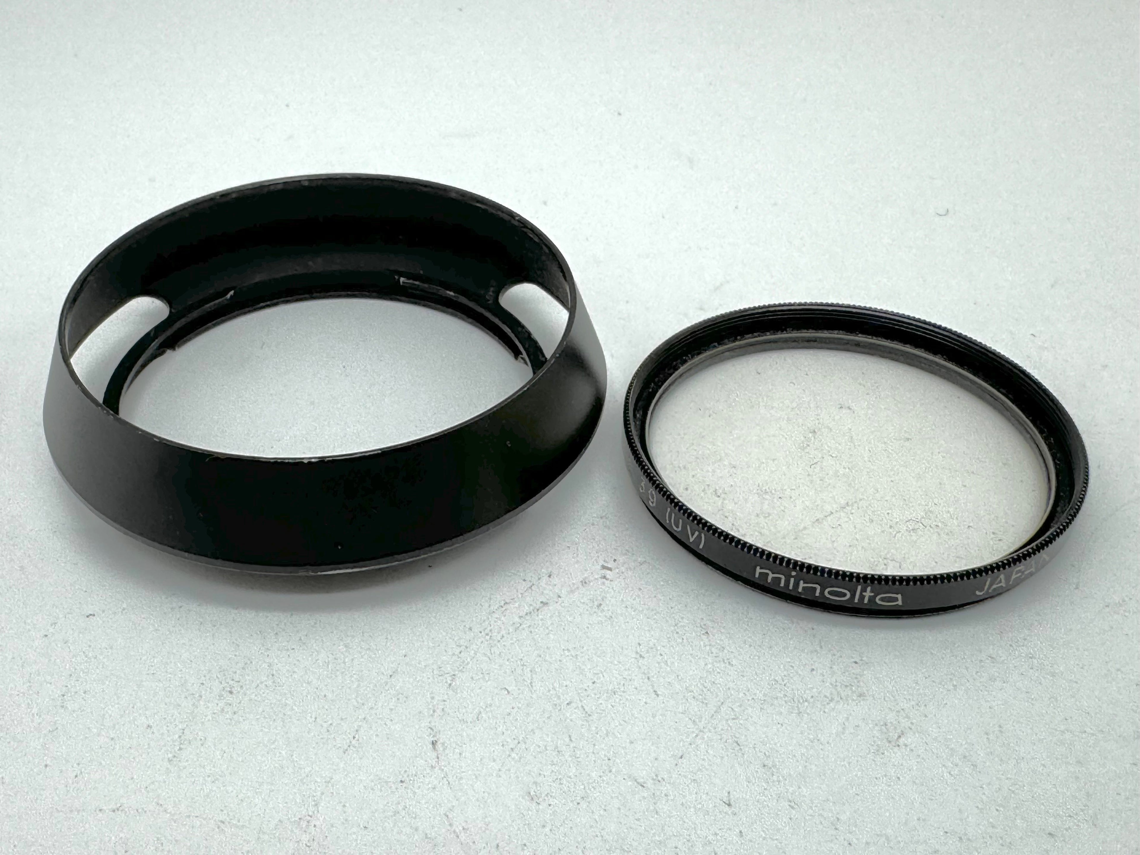 Used Minolta CLE Lens Hood for 28mm Lens and Minolta 37mm UV Glass Filter to suit.