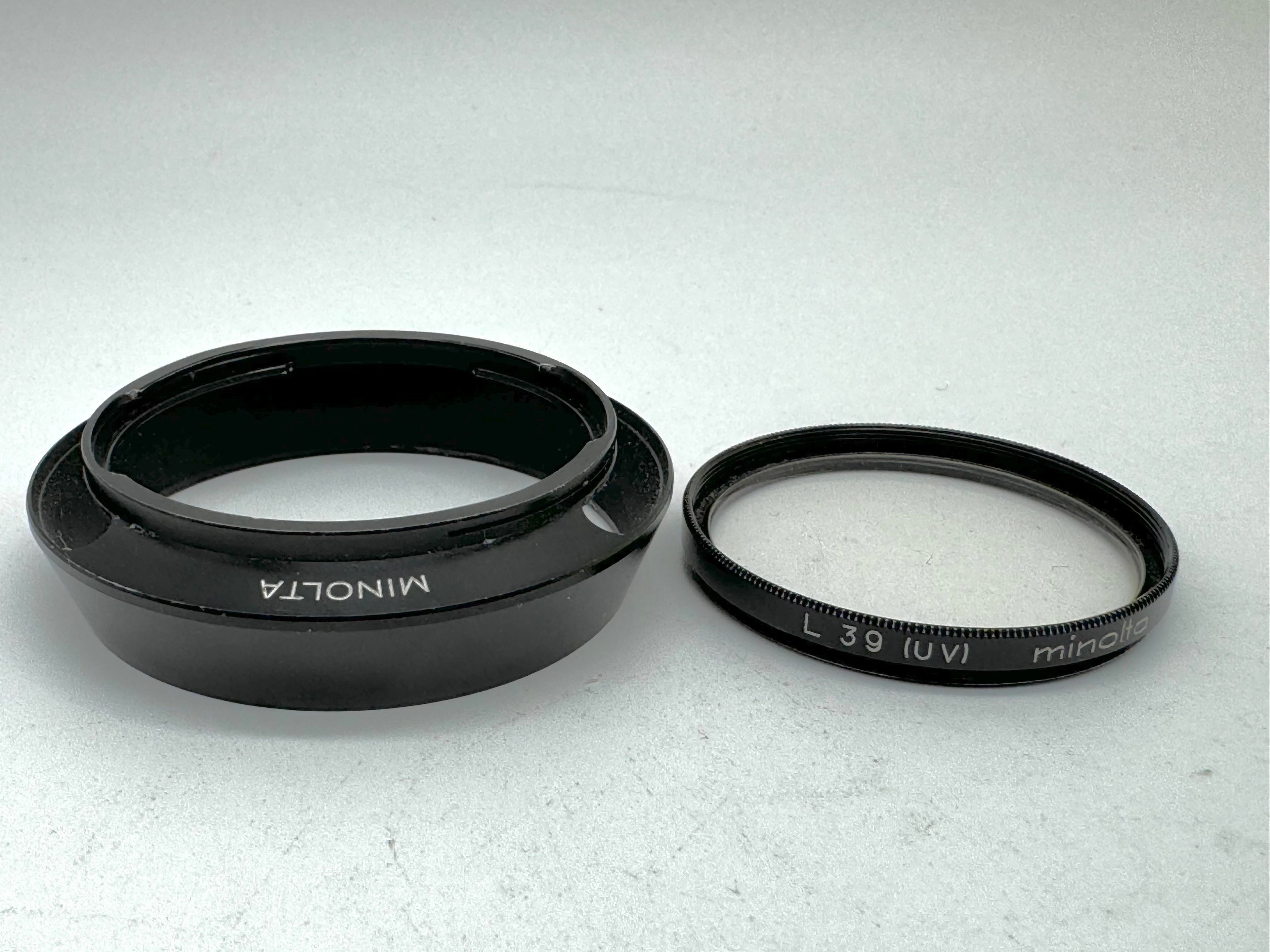 Used Minolta CLE Lens Hood for 28mm Lens and Minolta 37mm UV Glass Filter to suit.