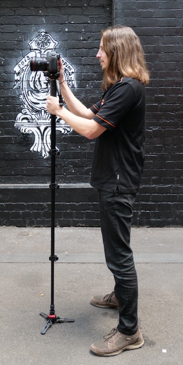 Holding a monopod - profile