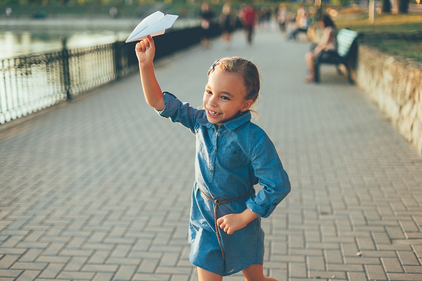 Little girl with paper airplane