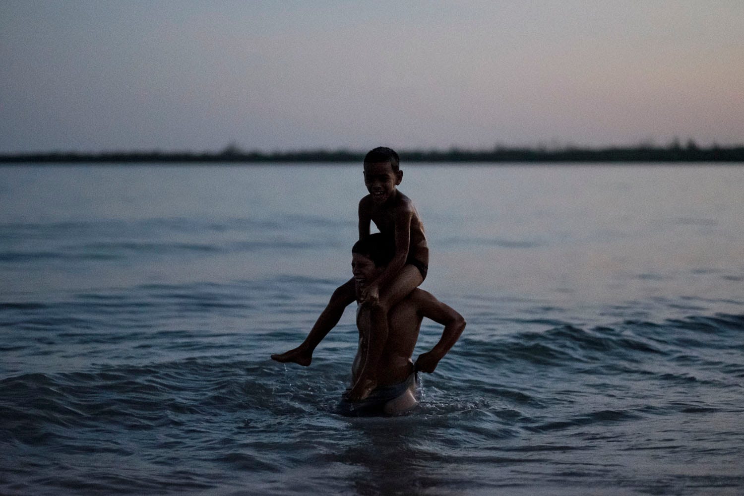 Boys laughing in ocean