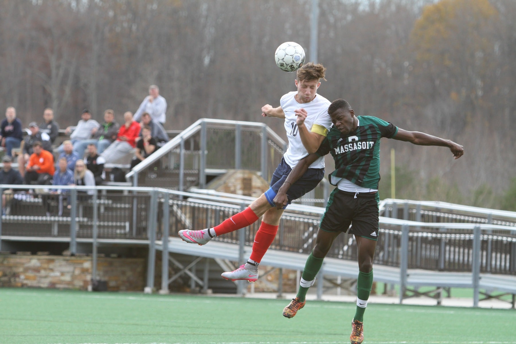 Football players jump for a ball