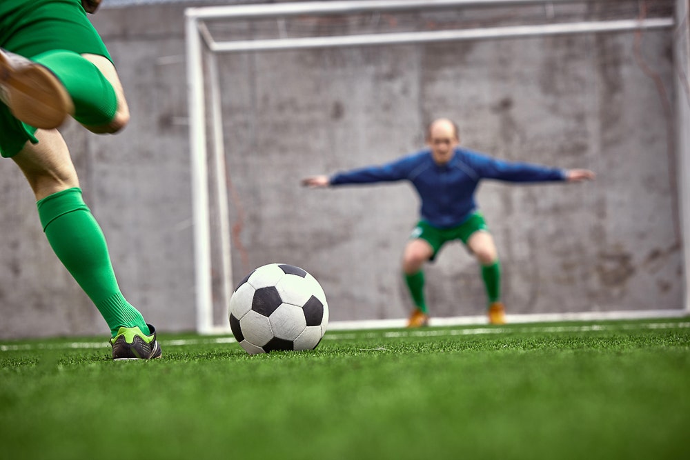 Soccer player kicks a goal